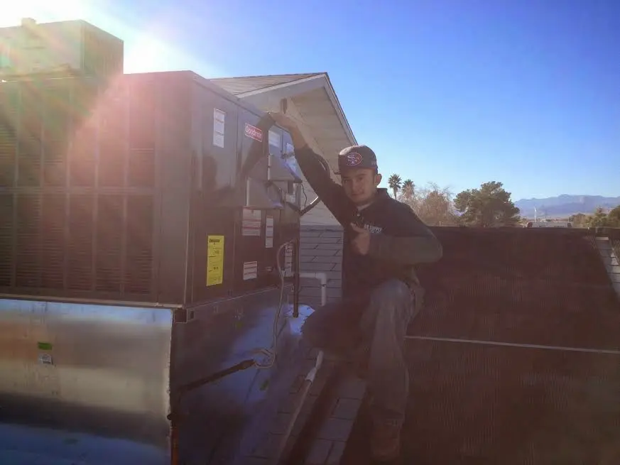 HVAC technician performing Boiler Repair on a rooftop unit in Atlanta